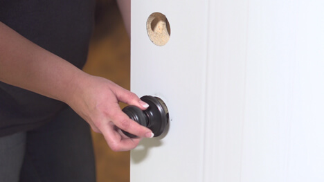 Person Removing Door Hardware